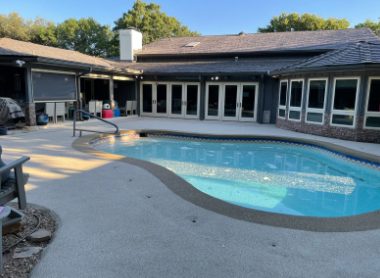 Freeform pool with concrete deck before rubber surfacing